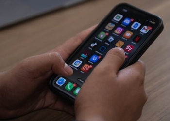 A pair of hands hold a smartphone