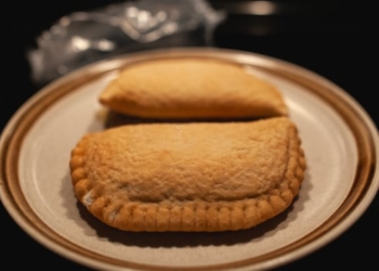 A pair of Pillsbury brand Pizza Pops are seen on a plate.