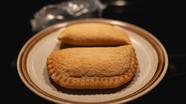 A pair of Pillsbury brand Pizza Pops are seen on a plate.