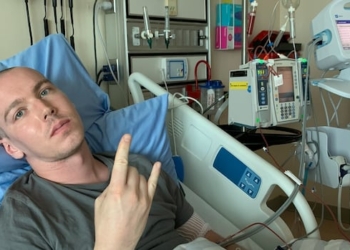 A man lying in a hospital bed