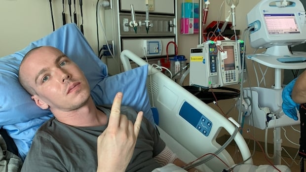 A man lying in a hospital bed