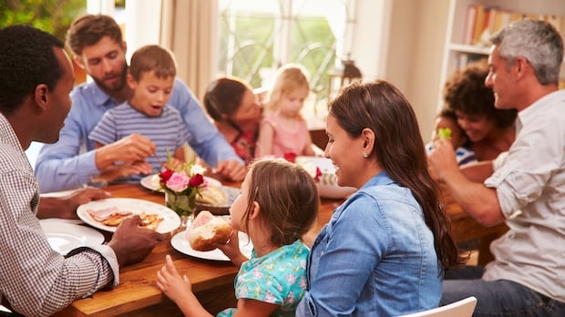 Family and friends sitting at a dining table
