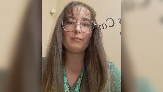 A woman is looking down and has a serious face.