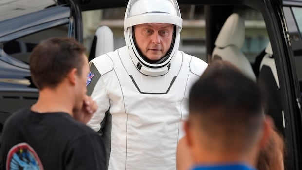 An astronaut speaks as leaves for a trip to the Kennedy Space Center's Launch Pad 39-A and a planned liftoff on a SpaceX Falcon 9 rocket Aug. 1, 2025, in Cape Canaveral , Fla.