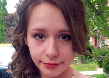 A young woman in a dress is seen.