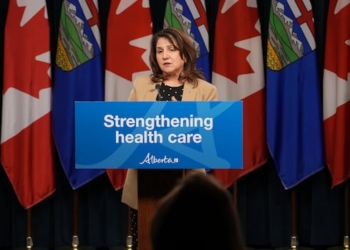 Woman in blazer at podium