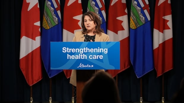 Woman in blazer at podium