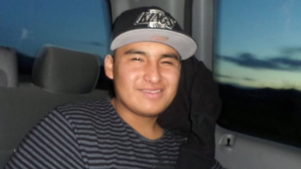 A young man sitting in a car.