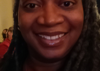 A close-up selfie of a woman smiling