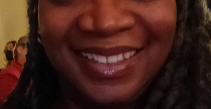 A close-up selfie of a woman smiling