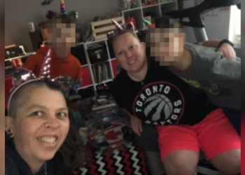 two women, two boys smiling