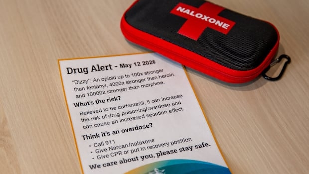 A naloxone kit is seen on a table with a piece of paper.