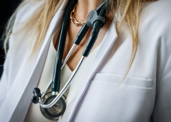 A stethoscope hangs around a female doctor's neck.