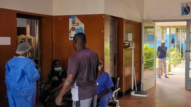 people in a hospital in PPE gather around each other