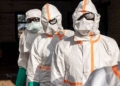 Workers line up to disinfect their protective equipment at General Referral Hospital of Mongbwalu during the Ebola outbreak response in Mongbwalu, Ituri province, eastern Democratic Republic of Congo, May 20.
