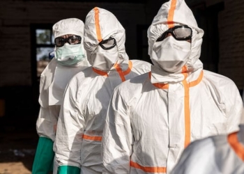Workers line up to disinfect their protective equipment at General Referral Hospital of Mongbwalu during the Ebola outbreak response in Mongbwalu, Ituri province, eastern Democratic Republic of Congo, May 20.