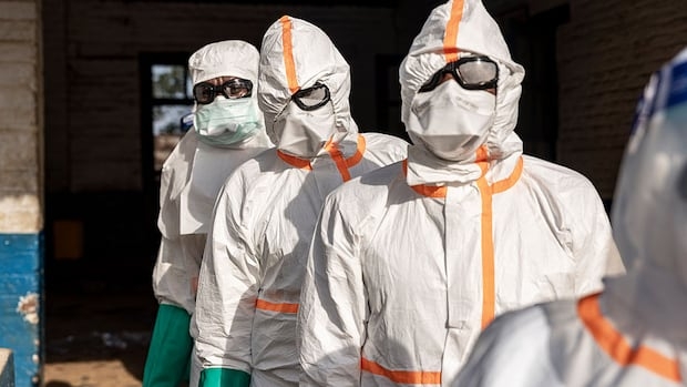Workers line up to disinfect their protective equipment at General Referral Hospital of Mongbwalu during the Ebola outbreak response in Mongbwalu, Ituri province, eastern Democratic Republic of Congo, May 20.